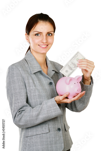 Photo: Young beautiful woman standing with piggy bank (money box) Young beautiful woman standing with piggy bank (money box)