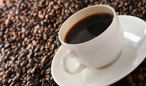 Photo: coffee beans with white cup coffee beans with white cup