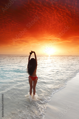 Photo: Woman in bikini on beach Woman in bikini on beach