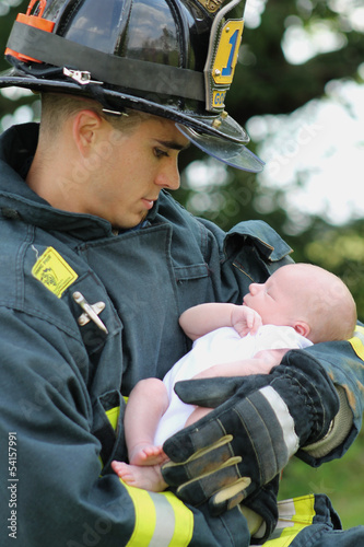 Photo: Firefighter Holding Baby Firefighter Holding Baby
