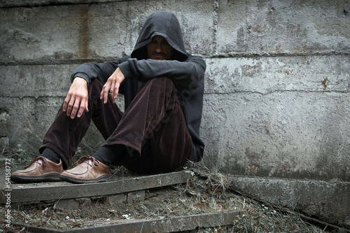 Photo: A lone homeless man on the street. A lone homeless man on the street.