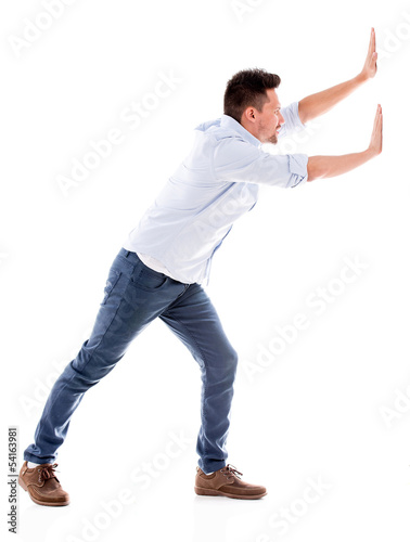 Photo: Man pushing something Man pushing something