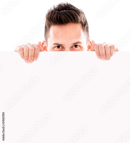 Photo: Man hiding behind banner Man hiding behind banner