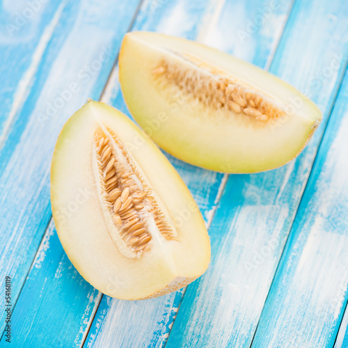 Photo: Two slices of a ripe Galia melon, close-up, studio shot Two slices of a ripe Galia melon, close-up, studio shot