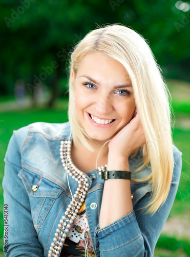 Photo: Young blond girl listening player Young blond girl listening player