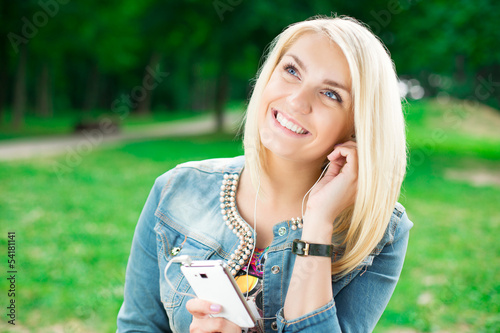Photo: Young blond girl listening player Young blond girl listening player