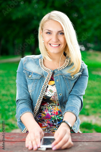 Photo: Young blond girl listening player Young blond girl listening player