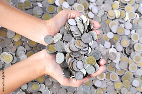 Photo: a lot of coins in hands a lot of coins in hands