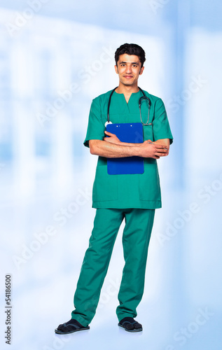 Photo: Portrait of the smiling arab doctor on interior Portrait of the smiling arab doctor on interior