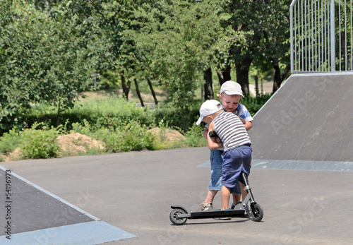 Photo: Two brothers fighting over a scooter Two brothers fighting over a scooter