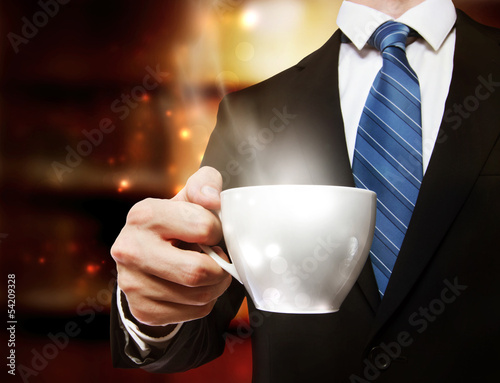 Photo: Business Man Holding a Cup of Coffee Business Man Holding a Cup of Coffee