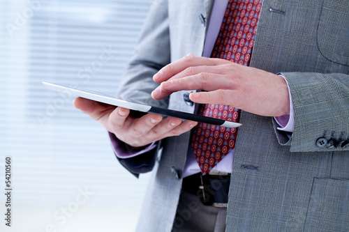 Photo: Male hands touching digital tablet Male hands touching digital tablet