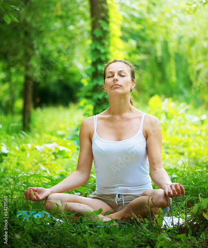 Photo: Yoga. Young woman doing yoga exercise outdoor Yoga. Young woman doing yoga exercise outdoor