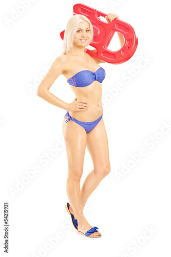 Photo: Female in bikini holding a swimming float Female in bikini holding a swimming float
