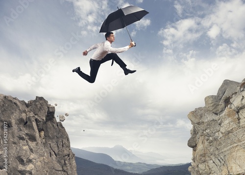 Photo: Businessman jumping over the mountains Businessman jumping over the mountains