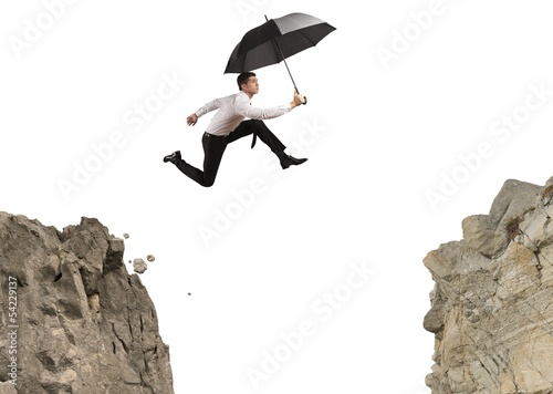 Photo: Businessman jumping over the mountains Businessman jumping over the mountains