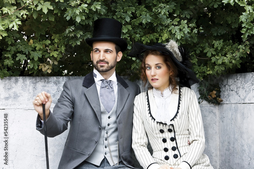Photo: Old-fashioned dressed couple in the park Old-fashioned dressed couple in the park