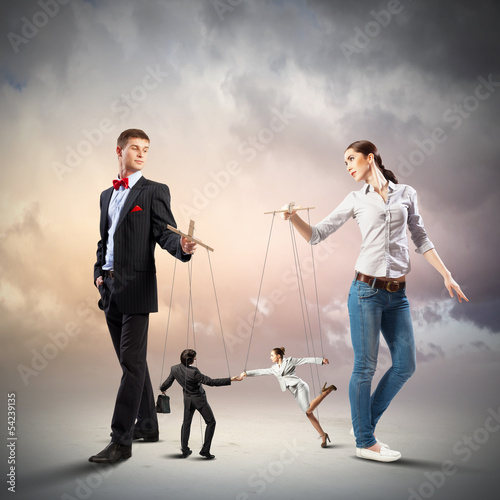 Photo: Businesspeople with marionettes Businesspeople with marionettes