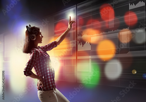 Photo: Woman touching virtual screen Woman touching virtual screen