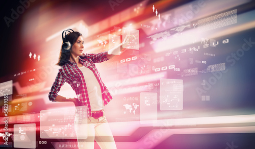 Photo: Woman touching virtual screen Woman touching virtual screen
