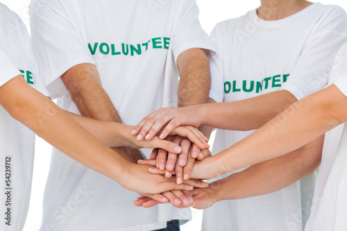 Photo: Group of volunteers putting hands together Group of volunteers putting hands together