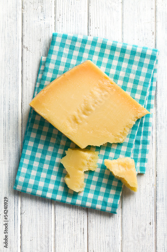 Photo: pieces of Italian hard cheese on a wooden table pieces of Italian hard cheese on a wooden table