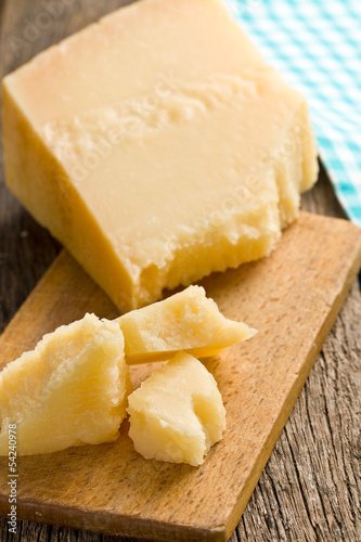 Photo: pieces of Italian hard cheese on a wooden table pieces of Italian hard cheese on a wooden table