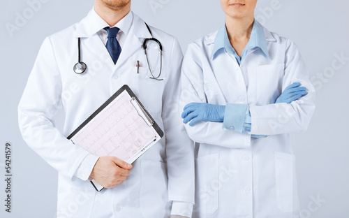 Photo: nurse and male doctor holding cardiogram nurse and male doctor holding cardiogram