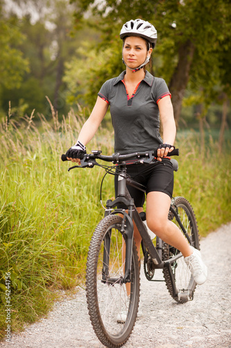 Photo: Portrait of woman with mountain bike Portrait of woman with mountain bike