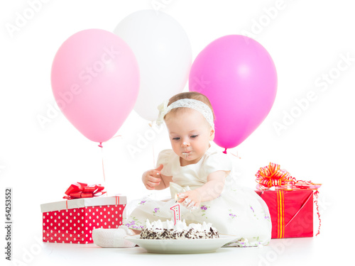 Photo: baby girl touching light on birthday cake baby girl touching light on birthday cake
