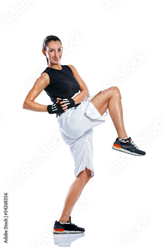 Photo: Young woman practicing kicking Young woman practicing kicking