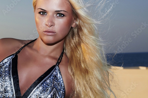 Photo: Beautiful blond woman on Santorini roof. green eyes Beautiful blond woman on Santorini roof. green eyes