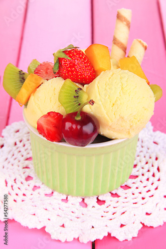 Photo: Delicious ice cream with fruits and berries in bowl Delicious ice cream with fruits and berries in bowl