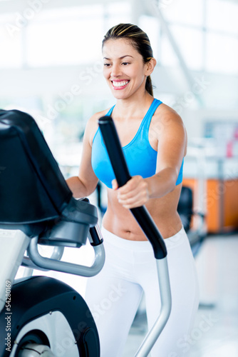 Photo: Woman exercising at the gym Woman exercising at the gym
