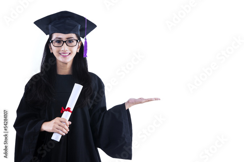 Photo: Beautiful graduate hold certificate - isolated Beautiful graduate hold certificate - isolated