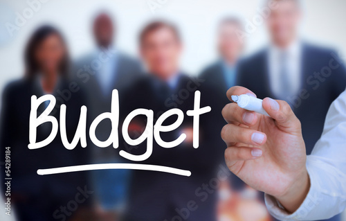 Photo: Businessman writing budget with a marker Businessman writing budget with a marker