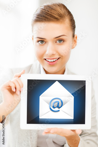 Photo: businesswoman holding tablet pc with email sign businesswoman holding tablet pc with email sign