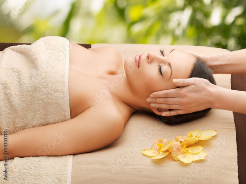 Photo: woman in spa getting facial massage woman in spa getting facial massage