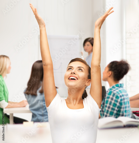 Photo: happy student girl with hands up happy student girl with hands up