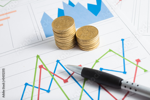 Photo: Euro coins on a financial chart Euro coins on a financial chart