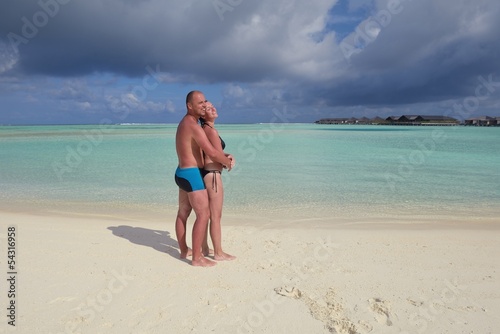 Photo: happy young couple at summer vacation have fun and relax at bea happy young couple at summer vacation have fun and relax at bea