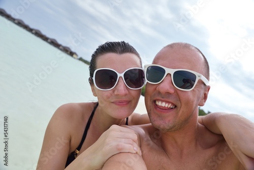 Photo: happy young couple at summer vacation have fun and relax at bea happy young couple at summer vacation have fun and relax at bea