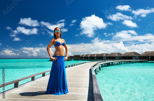Photo: Woman on a beach jetty at Maldives Woman on a beach jetty at Maldives
