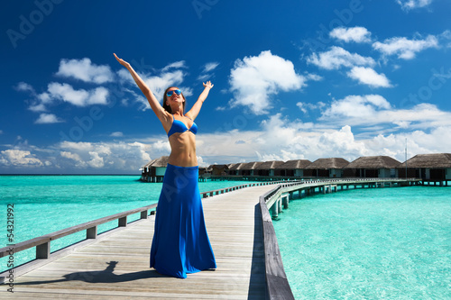 Photo: Woman on a beach jetty at Maldives Woman on a beach jetty at Maldives