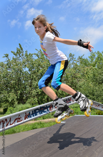 Photo: Agile young girl roller skating Agile young girl roller skating