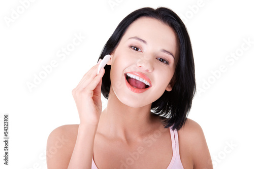 Photo: Young beautiful caucasian woman using a cotton pad Young beautiful caucasian woman using a cotton pad