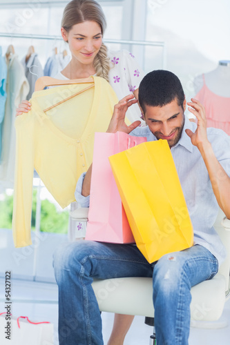 Photo: Angry man while his girlfriend is shopping Angry man while his girlfriend is shopping