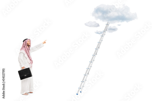 Photo: Male arab person with briefcase standing in front of a ladder Male arab person with briefcase standing in front of a ladder