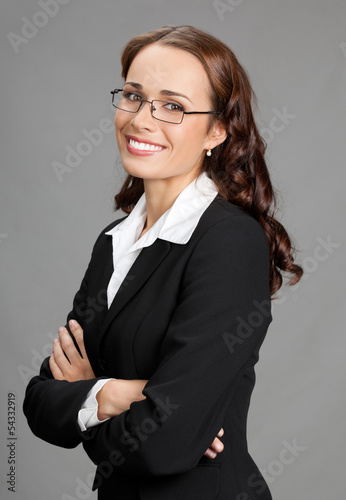 Photo: Smiling businesswoman, over gray Smiling businesswoman, over gray