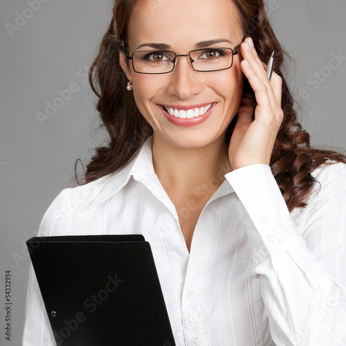 Photo: Businesswoman with folder, on gray Businesswoman with folder, on gray